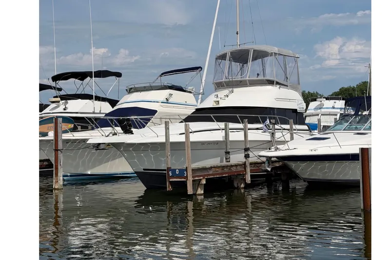 Slide: The Image of A 1995 Silverton 37 Convertible is docked in a marina. - 50