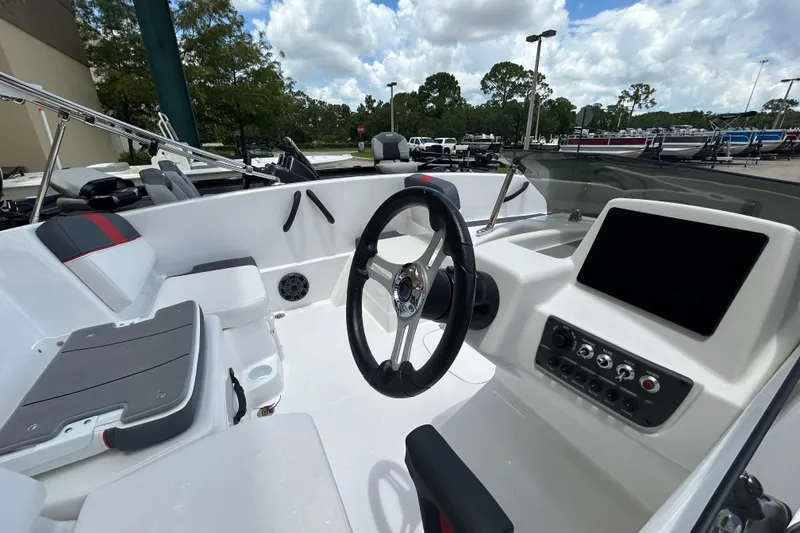 Slide: The Image of Interior view of 2026 Tahoe T16 boat, featuring steering wheel and control panel. - 5