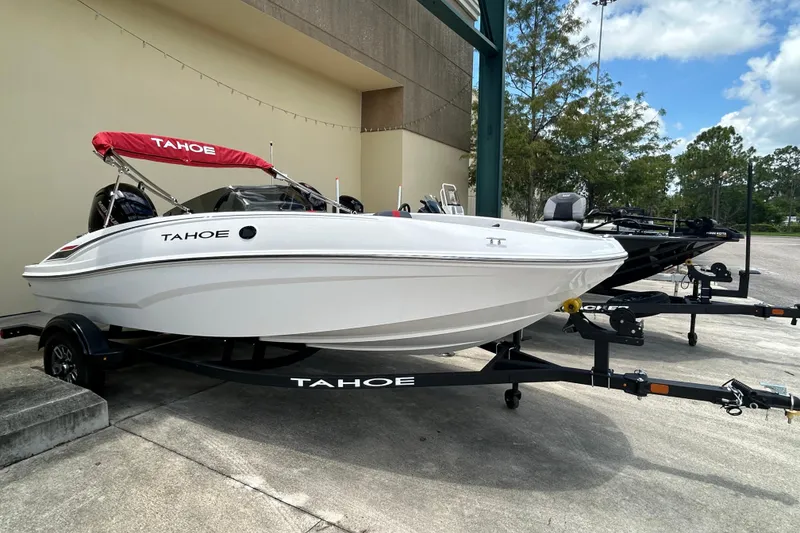 The Image of 2026 Tahoe T16 boat with red canopy on trailer, parked outdoors. - 0