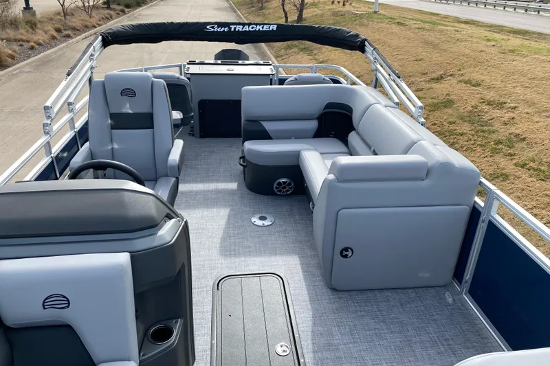 Slide: The Image of 2026 Sun Tracker SportFish 22 XP3 pontoon boat interior with gray seating and helm. - 3