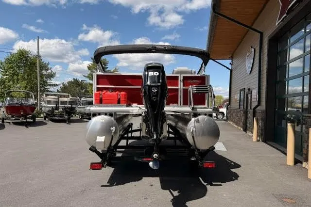 Slide: The Image of 2026 Sun Tracker Party Barge 16 DLX pontoon boat with 50 HP engine, parked outdoors. - 64