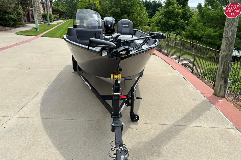Slide: The Image of 2026 Tracker Pro Guide V-16 SC boat on trailer, parked on a driveway. - 2