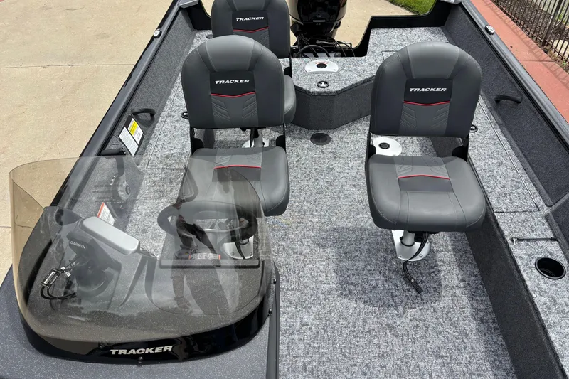 Slide: The Image of 2026 Tracker Pro Guide V-16 SC boat interior with gray seating and Garmin equipment. - 4