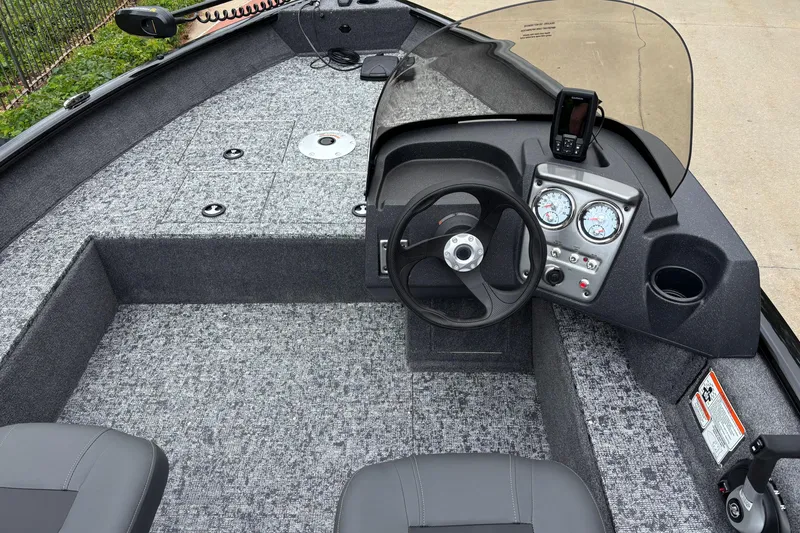 Slide: The Image of 2026 Tracker Pro Guide V-16 SC boat interior with steering wheel and dashboard controls. - 6