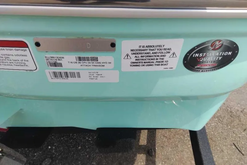 Slide: The Image of 2026 Tahoe T16 boat transom with safety and installation labels. - 15