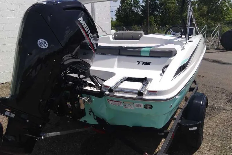 Slide: The Image of 2026 Tahoe T16 boat with Mercury engine, parked on a trailer outdoors. - 4