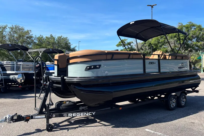 Slide: The Image of 2026 Regency 230 DL pontoon boat on trailer in parking lot. - 3