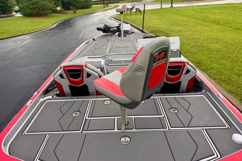Slide: The Image of 2026 Ranger Z521R Cup-Equipped boat with red and gray seating on a paved path. - 36