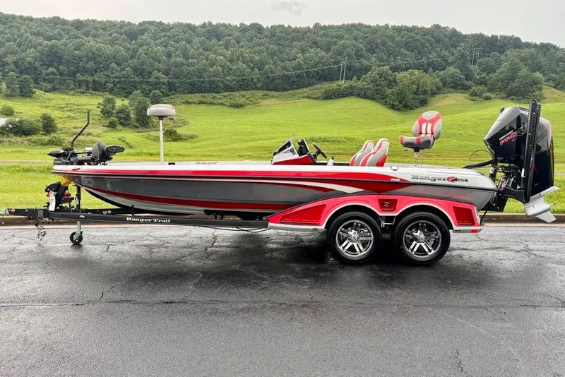 Slide: The Image of 2026 Ranger Z521R Cup-Equipped boat on trailer, red and gray design, scenic background. - 24