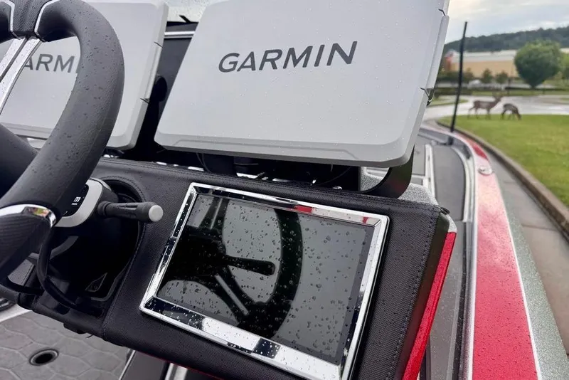 Slide: The Image of 2026 Ranger Z521R Cup-Equipped boat dashboard with Garmin navigation system, steering wheel, and raindrops. - 40