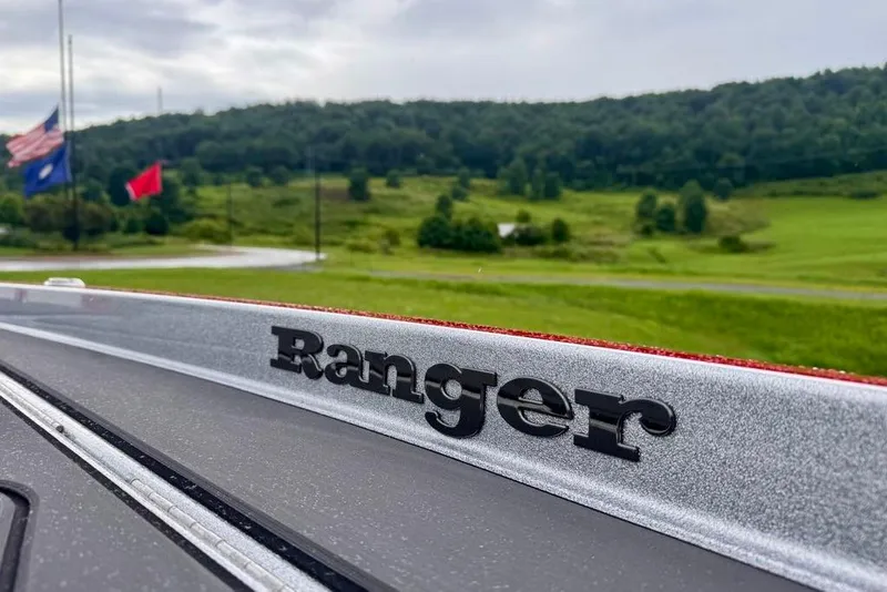 Slide: The Image of 2026 Ranger Z521R Cup-Equipped boat with scenic countryside backdrop. - 33