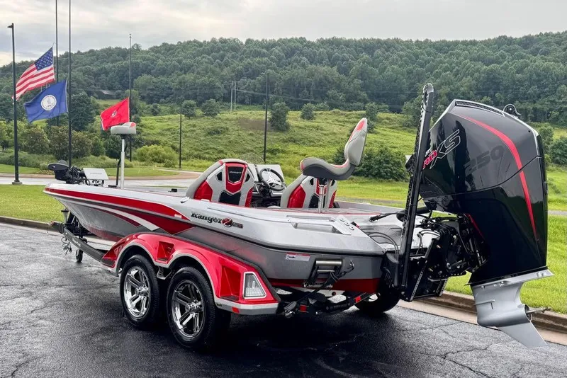 Slide: The Image of 2026 Ranger Z521R Cup-Equipped boat with powerful engine, parked outdoors near flags. - 128