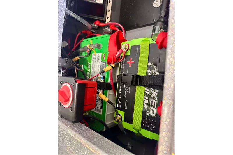 Slide: The Image of Battery compartment of 2026 Ranger Z521R Cup-Equipped boat with green and black batteries. - 45