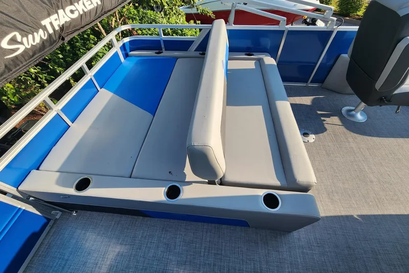Slide: The Image of 2026 Sun Tracker Party Barge 22 RF DLX interior with gray seating and cup holders. - 3