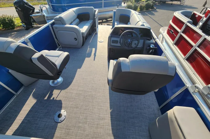 Slide: The Image of 2026 Sun Tracker Party Barge 22 RF DLX interior with seating and steering console. - 4