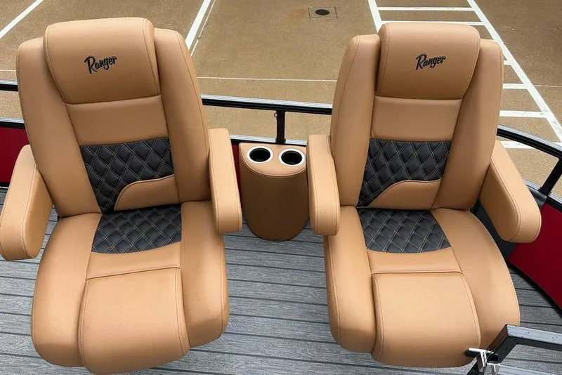 Slide: The Image of Luxurious tan and black leather seats on a 2026 Ranger 220FC boat, featuring cup holders. - 11
