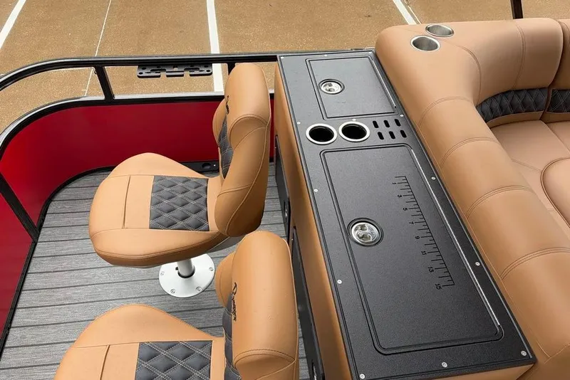 Slide: The Image of Interior of 2026 Ranger 220FC boat with tan seating and black console. - 9