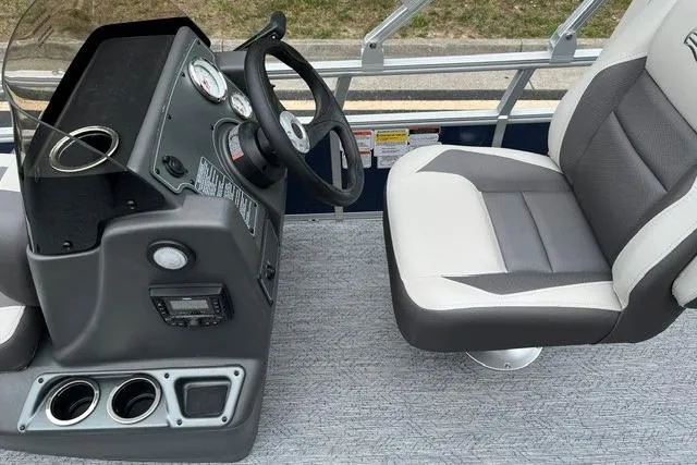 Slide: The Image of 2026 Sun Tracker Bass Buggy 18 DLX boat interior with steering console and cushioned seat. - 5
