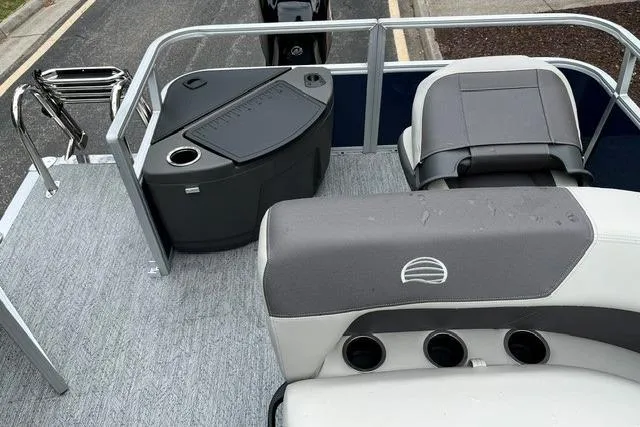 Slide: The Image of 2026 Sun Tracker Bass Buggy 18 DLX pontoon boat interior with seating and storage. - 6