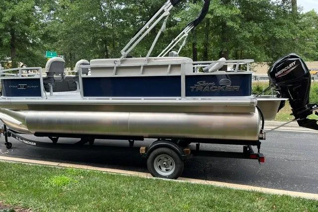 Slide: The Image of 2026 Sun Tracker Bass Buggy 18 DLX pontoon boat with Mercury outboard motor on trailer. - 10