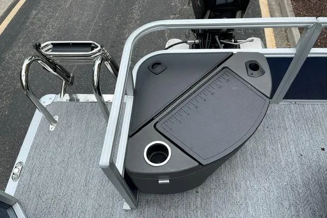 Slide: The Image of 2026 Sun Tracker Bass Buggy 18 DLX boat deck with storage and cup holder. - 9