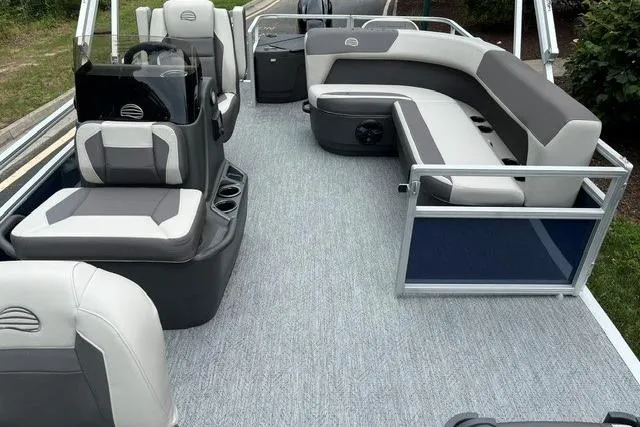 Slide: The Image of 2026 Sun Tracker Bass Buggy 18 DLX pontoon boat interior with gray seating and flooring. - 4