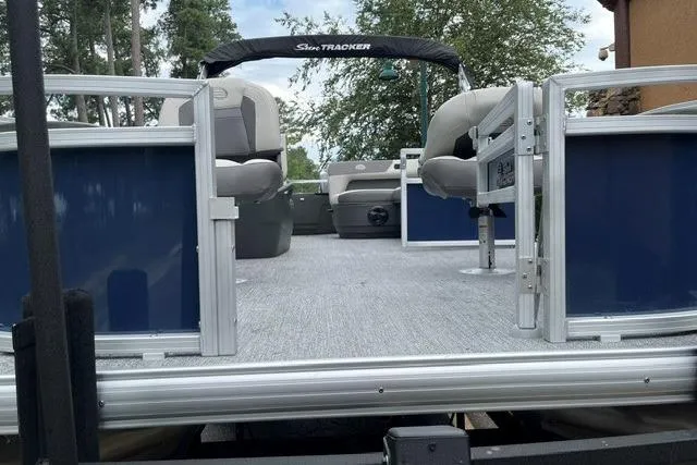 Slide: The Image of 2026 Sun Tracker Bass Buggy 18 DLX pontoon boat with spacious seating and open deck. - 2