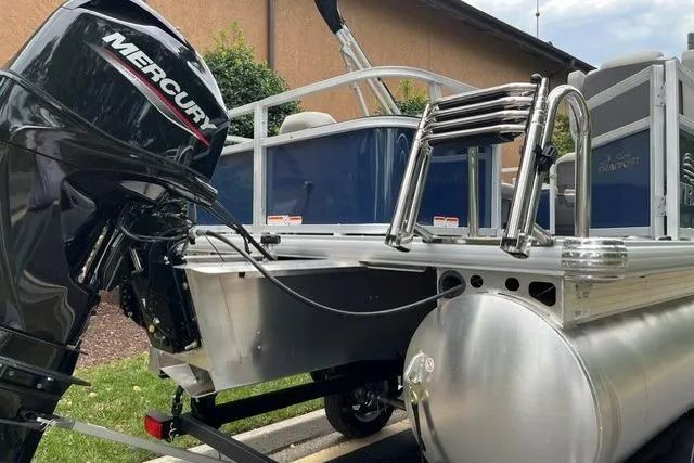 Slide: The Image of 2026 Sun Tracker Bass Buggy 18 DLX pontoon boat with Mercury outboard motor. - 11