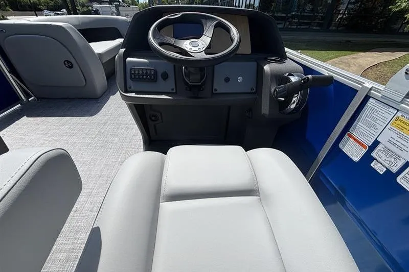Slide: The Image of Interior view of 2026 Sun Tracker Party Barge 18 DLX, featuring steering console and seating. - 7