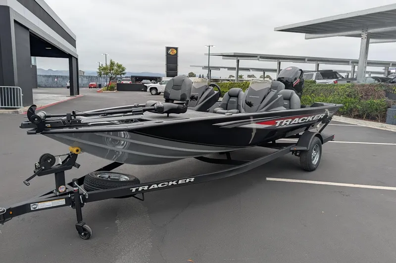 Slide: The Image of 2026 Tracker Pro Team 195 boat on trailer in parking lot, showcasing sleek design and modern features. - 3