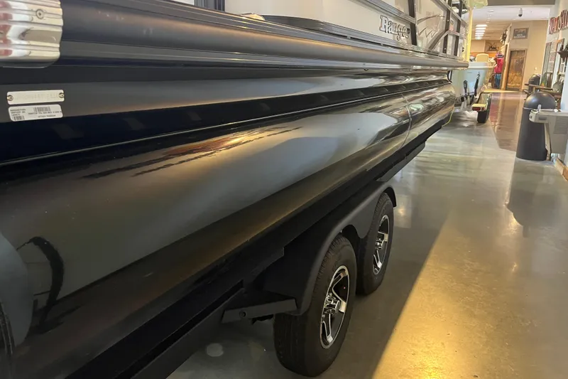 Slide: The Image of 2026 Ranger 220F boat on trailer in showroom, side view. - 3