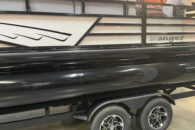 Slide: The Image of 2026 Ranger 220F boat on trailer, featuring sleek black design and stylish wheels. - 2