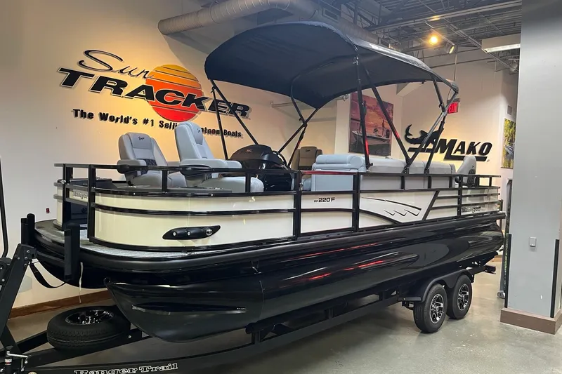 The Image of 2026 Ranger 220F pontoon boat displayed indoors with canopy and seating. - 0