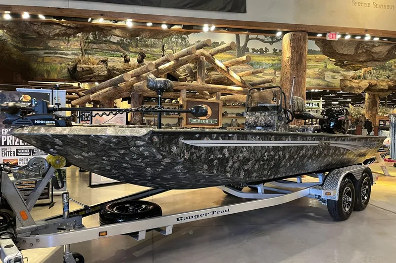 The Image of 2026 Ranger RB200 boat with camouflage design on display in a showroom. - 0