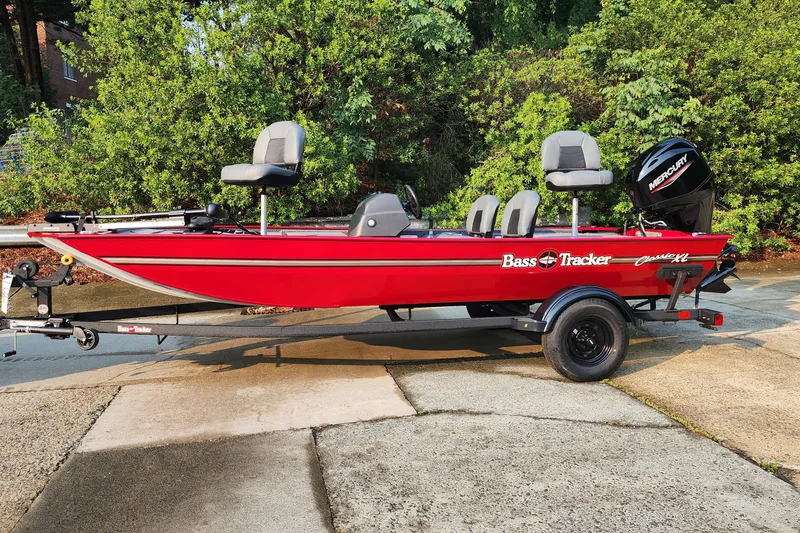 The Image of 2026 Tracker Bass Tracker Classic XL boat, red, on trailer, with Mercury outboard motor. - 0
