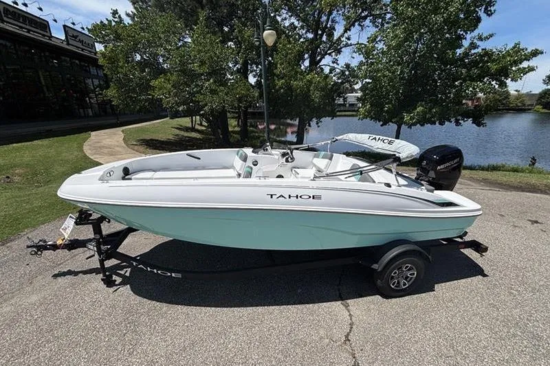 Slide: The Image of 2026 Tahoe T18 boat on trailer by a lake, under clear skies. - 0