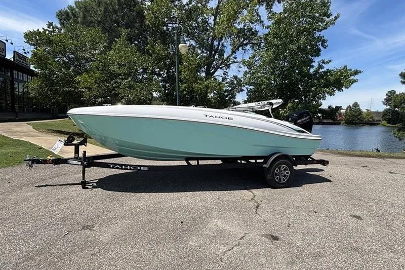 Slide: The Image of 2026 Tahoe T18 boat on trailer by a lake, surrounded by trees. - 1