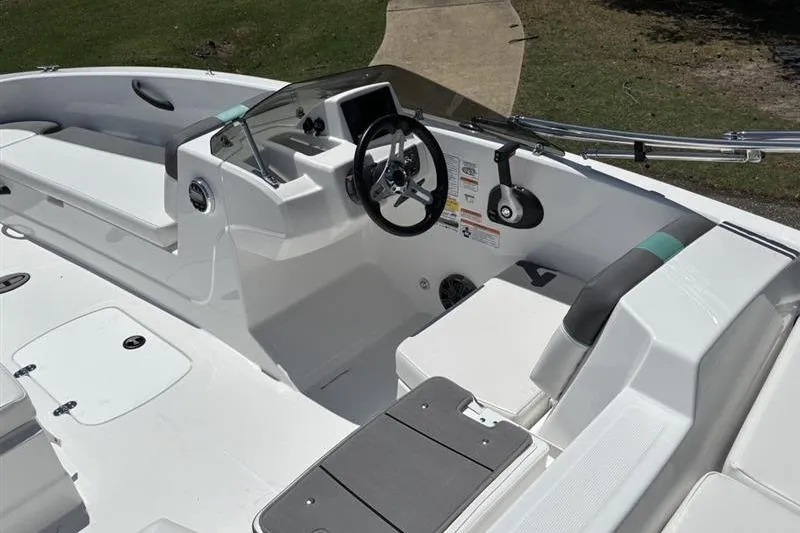Slide: The Image of 2026 Tahoe T18 boat interior with steering wheel and seating, showcasing modern design. - 12