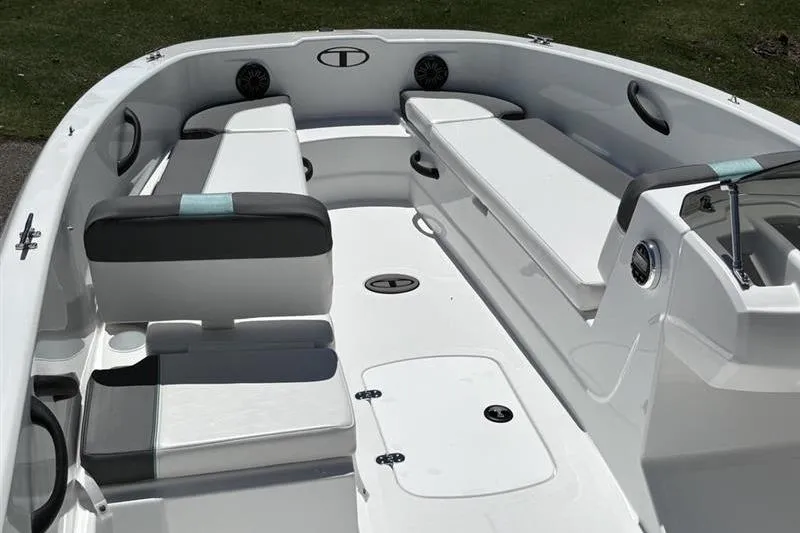 Slide: The Image of 2026 Tahoe T18 boat interior with white seating and storage compartments. - 13