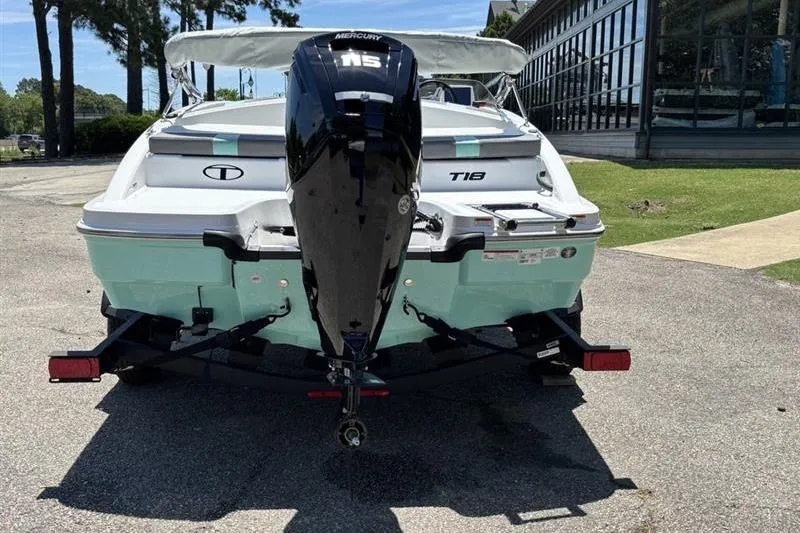 Slide: The Image of 2026 Tahoe T18 boat with Mercury engine, parked on a trailer outdoors. - 5
