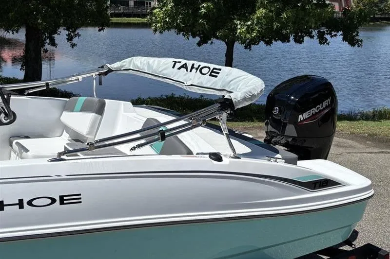 Slide: The Image of 2026 Tahoe T18 boat with Mercury engine by a serene lake. - 6