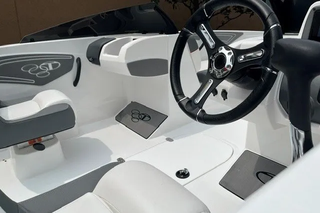 Slide: The Image of Interior of a 2026 Tahoe T21 boat featuring sleek steering and modern seating design. - 5