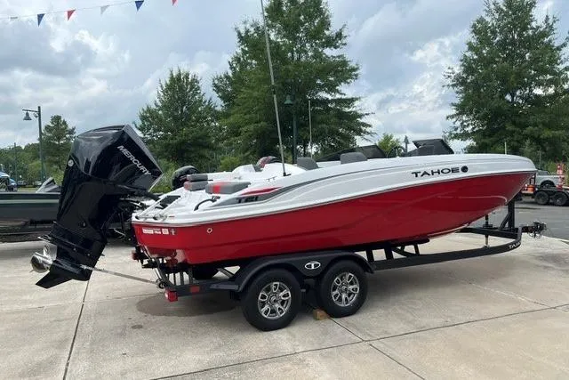 The Image of Red and white 2026 Tahoe T21 boat on trailer, parked outdoors. - 0