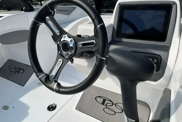 Slide: The Image of Steering wheel and dashboard of 2026 Tahoe T21 boat, featuring modern controls and design. - 4