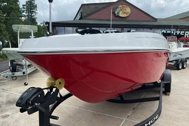 Slide: The Image of 2026 Tahoe T21 boat with red hull on trailer outside Bass Pro Shops. - 2