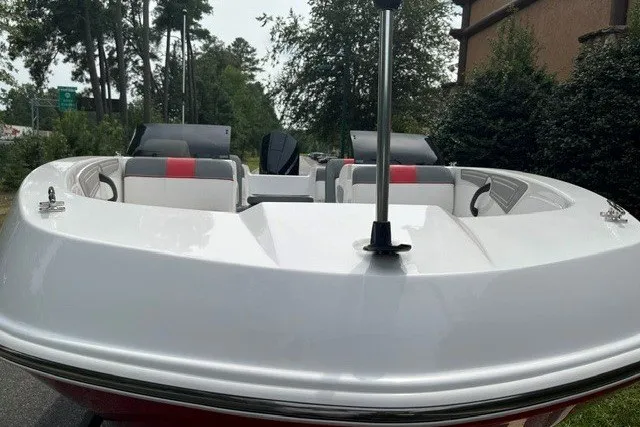 Slide: The Image of 2026 Tahoe T21 boat with sleek design, white and red seating, outdoor setting. - 2
