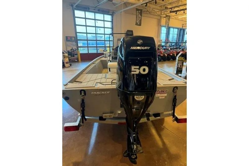 Slide: The Image of 2026 Tracker Bass Tracker Classic CC with Mercury 50 outboard motor in showroom. - 2