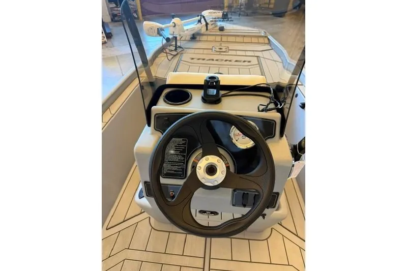 Slide: The Image of 2026 Tracker Bass Tracker Classic CC boat dashboard with steering wheel and controls. - 6