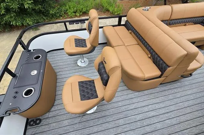 Slide: The Image of 2026 Ranger 220F boat interior with tan and black seating, featuring modern design and amenities. - 13
