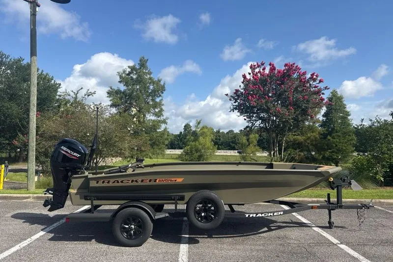 The Image of 2026 Tracker Grizzly 1756 T Marsh boat on trailer in scenic outdoor setting. - 0